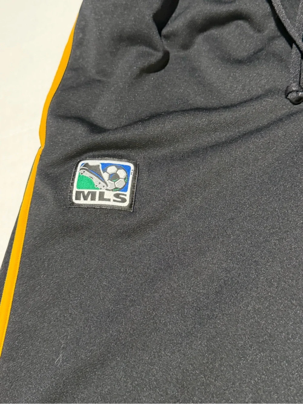Nike Black Joggers with Yellow Side Stripe and Gold Swoosh